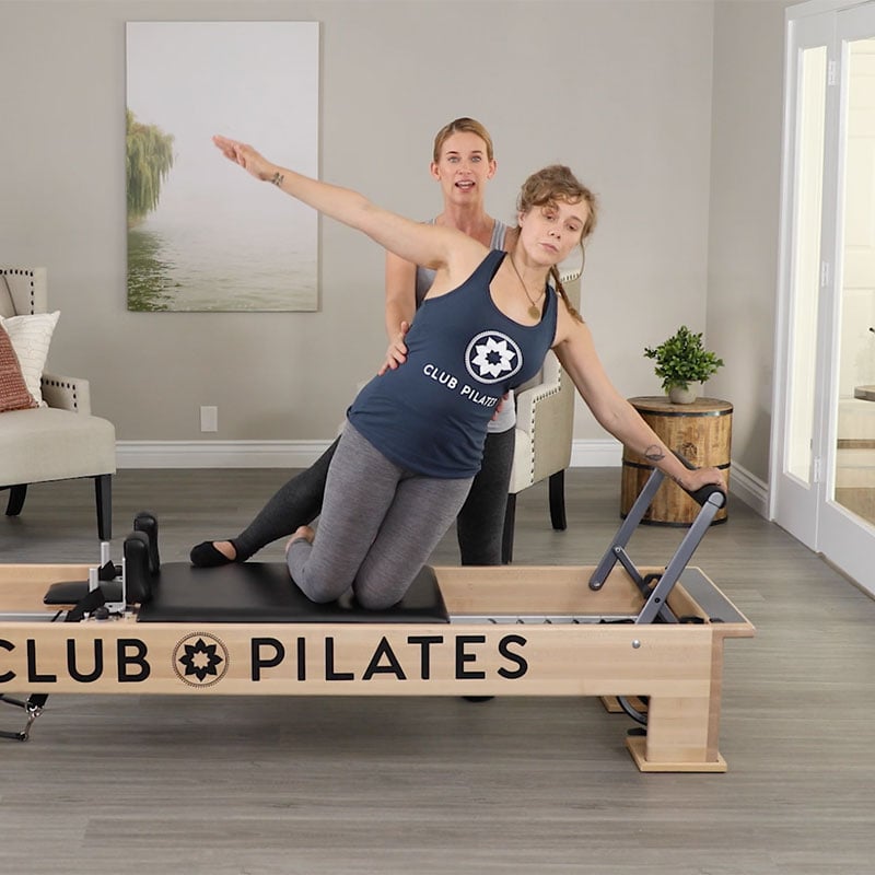 Club Pilates instructor guiding person working out at Club Pilates